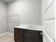 Laundry room with gray walls, tile floors, wire shelves and wood cabinets at 617 Mosaic Blvd, Daytona Beach, FL 32124