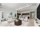 Open living space featuring modern decor, a kitchen island with seating, and a neutral color palette at 617 Mosaic Blvd, Daytona Beach, FL 32124