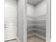Pantry with white walls, tile floors, wire shelves and a white door at 617 Mosaic Blvd, Daytona Beach, FL 32124