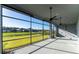 Large patio with high ceilings, ceiling fans, and floor to ceiling windows overlooking the green lawn at 617 Mosaic Blvd, Daytona Beach, FL 32124