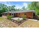 A brick house is shown with a patio and landscaping at 6185 Shoreline Dr, Port Orange, FL 32127