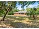 Sprawling backyard with lawn, mature trees, and well-maintained landscaping at 6185 Shoreline Dr, Port Orange, FL 32127