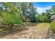 Picturesque backyard with trees, green shrubs, and lots of shaded area at 6185 Shoreline Dr, Port Orange, FL 32127