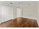 Bright bedroom featuring hardwood floors, a ceiling fan, and double closet at 6185 Shoreline Dr, Port Orange, FL 32127