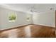 Bedroom featuring hardwood floors and two windows at 6185 Shoreline Dr, Port Orange, FL 32127