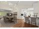 Elegant dining room with wood floors, white kitchen, modern light fixture, and seating for eight at 6185 Shoreline Dr, Port Orange, FL 32127