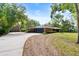 Sprawling single-story brick home with an attached garage, long driveway, and a detached garage on a large lot at 6185 Shoreline Dr, Port Orange, FL 32127