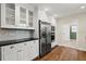 White kitchen with stainless steel appliances, cabinets and drawers and hardwood flooring at 6185 Shoreline Dr, Port Orange, FL 32127