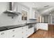 A modern kitchen featuring white cabinets, stainless steel appliances, and a stylish tile backsplash at 6185 Shoreline Dr, Port Orange, FL 32127