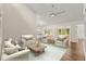 Bright living room with hardwood floors, neutral furniture, and access to a modern kitchen at 6185 Shoreline Dr, Port Orange, FL 32127