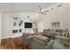 Bright living room with vaulted ceiling, built-in shelves, and hardwood floors at 6185 Shoreline Dr, Port Orange, FL 32127