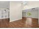 Spacious living room featuring hardwood floors, high ceilings, built-in shelving, and ample natural light at 6185 Shoreline Dr, Port Orange, FL 32127