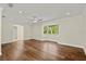 Bright living room with hardwood floors, neutral paint, and a large window offering scenic views at 6185 Shoreline Dr, Port Orange, FL 32127