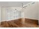 Large living room with hardwood floors, white built-ins, vaulted ceilings, and abundant natural light at 6185 Shoreline Dr, Port Orange, FL 32127