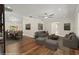 Comfortable living room with hardwood floors, neutral tones, dining area, and plush seating at 6185 Shoreline Dr, Port Orange, FL 32127