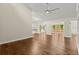 Open-concept living room with hardwood floors and great natural light from windows and glass doors at 6185 Shoreline Dr, Port Orange, FL 32127