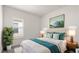 Inviting bedroom with a queen bed, stylish decor, and large window at 633 Mosaic Blvd, Daytona Beach, FL 32124