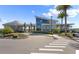Community clubhouse featuring modern architecture, well-manicured landscaping, and accessible parking at 633 Mosaic Blvd, Daytona Beach, FL 32124