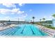 Community pool with swim lanes and inviting lounge areas surrounded by lush landscaping, ideal for leisure at 633 Mosaic Blvd, Daytona Beach, FL 32124