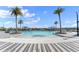 Expansive community pool with zero entry, lounge chairs, and shade cabanas, perfect for relaxation and fun at 633 Mosaic Blvd, Daytona Beach, FL 32124