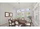 Dining room featuring a wood table, decorative chandelier, large windows, and neutral wall color at 633 Mosaic Blvd, Daytona Beach, FL 32124