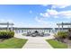 Outdoor fire pit area with seating, surrounded by landscaping, and overlooking a serene lake with fountains at 633 Mosaic Blvd, Daytona Beach, FL 32124