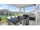 Screened-in patio with an outdoor kitchen and dining area overlooking a lush backyard and neighborhood view at 633 Mosaic Blvd, Daytona Beach, FL 32124