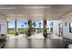 Open-air patio featuring tiled floors, columns with art, tables, and chairs, offering views of the pool and palm trees at 633 Mosaic Blvd, Daytona Beach, FL 32124