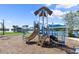 Community playground featuring slides, climbing structures, and views of the lake and surrounding neighborhood at 633 Mosaic Blvd, Daytona Beach, FL 32124