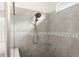 Close-up of a shower featuring tiled walls, a rainfall showerhead, and a built-in corner shelf at 633 Mosaic Blvd, Daytona Beach, FL 32124