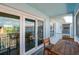 The screened in balcony has a table and chairs with views from the living area through sliding glass doors at 719 S Beach St # 302B, Daytona Beach, FL 32114