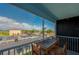 This screened-in balcony with a table and chairs, offers expansive parking lot views at 719 S Beach St # 302B, Daytona Beach, FL 32114