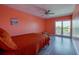 Comfortable bedroom with a window, ceiling fan, and an ocean-themed painting on the wall at 719 S Beach St # 302B, Daytona Beach, FL 32114