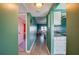 Hallway leading to the living room and kitchen with hardwood floors and colorful walls at 719 S Beach St # 302B, Daytona Beach, FL 32114