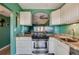 Kitchen with stainless steel appliances and a pass-through window to the living room at 719 S Beach St # 302B, Daytona Beach, FL 32114