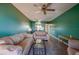 A comfortable living room with wood floors, light colored seating, and an adjacent open kitchen at 719 S Beach St # 302B, Daytona Beach, FL 32114