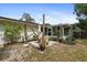 Inviting backyard patio area with a sunroom and decorative landscaping creating a cozy outdoor space at 736 Lindenwood W Cir, Ormond Beach, FL 32174