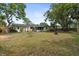 Large, lush backyard featuring lots of shade and a firepit at 736 Lindenwood W Cir, Ormond Beach, FL 32174