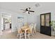 Cozy dining area features a stylish light fixture, wood table, and neutral décor at 736 Lindenwood W Cir, Ormond Beach, FL 32174