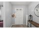 A welcoming entryway with a white paneled door, gray walls, and stylish decor sets an inviting tone at 736 Lindenwood W Cir, Ormond Beach, FL 32174