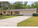 Charming single-story home with a well-maintained lawn, attached garage, and inviting curb appeal at 736 Lindenwood W Cir, Ormond Beach, FL 32174