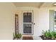 A cozy front porch featuring a decorative welcome sign, potted plants, and a 'hello' doormat at 736 Lindenwood W Cir, Ormond Beach, FL 32174