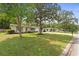 Charming single-story home with a well-maintained lawn and mature trees enhancing its curb appeal at 736 Lindenwood W Cir, Ormond Beach, FL 32174