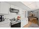 Modern kitchen features stainless steel appliances, white cabinets, and marble countertops at 736 Lindenwood W Cir, Ormond Beach, FL 32174