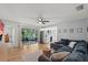 Cozy living room featuring a large sectional sofa, hardwood floors, and access to a screened-in porch at 736 Lindenwood W Cir, Ormond Beach, FL 32174