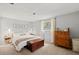 Tranquil main bedroom featuring soft colors, natural light, and classic wood furniture at 736 Lindenwood W Cir, Ormond Beach, FL 32174