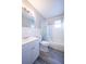 Bathroom with toilet, vanity, and tiled tub shower with curtain at 925 Halstead St, Deltona, FL 32725