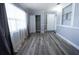 Spacious bedroom featuring contemporary gray walls, modern floors, and large window with curtains at 925 Halstead St, Deltona, FL 32725
