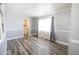 Light-filled bedroom featuring contemporary gray walls, modern floors, and neutral-tone curtains at 925 Halstead St, Deltona, FL 32725