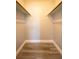 Empty closet features wood-look floors and built in shelf at 925 Halstead St, Deltona, FL 32725